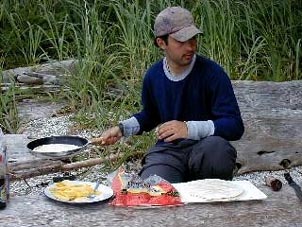 Trip leader Frank McCurdy whips up feast for the hungry group. Cpoyright Rick Hudson.