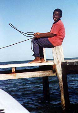 A Garifuna youth enjoys the moment on a Hopkins pier. Copyright Jim Johnson.